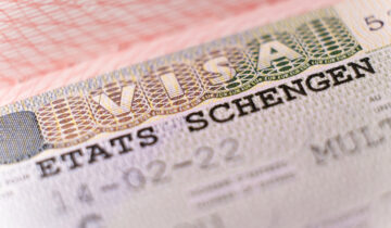 Macro shot biometric passport with schengen visa. European visitor visa for tourism and travel in EU.