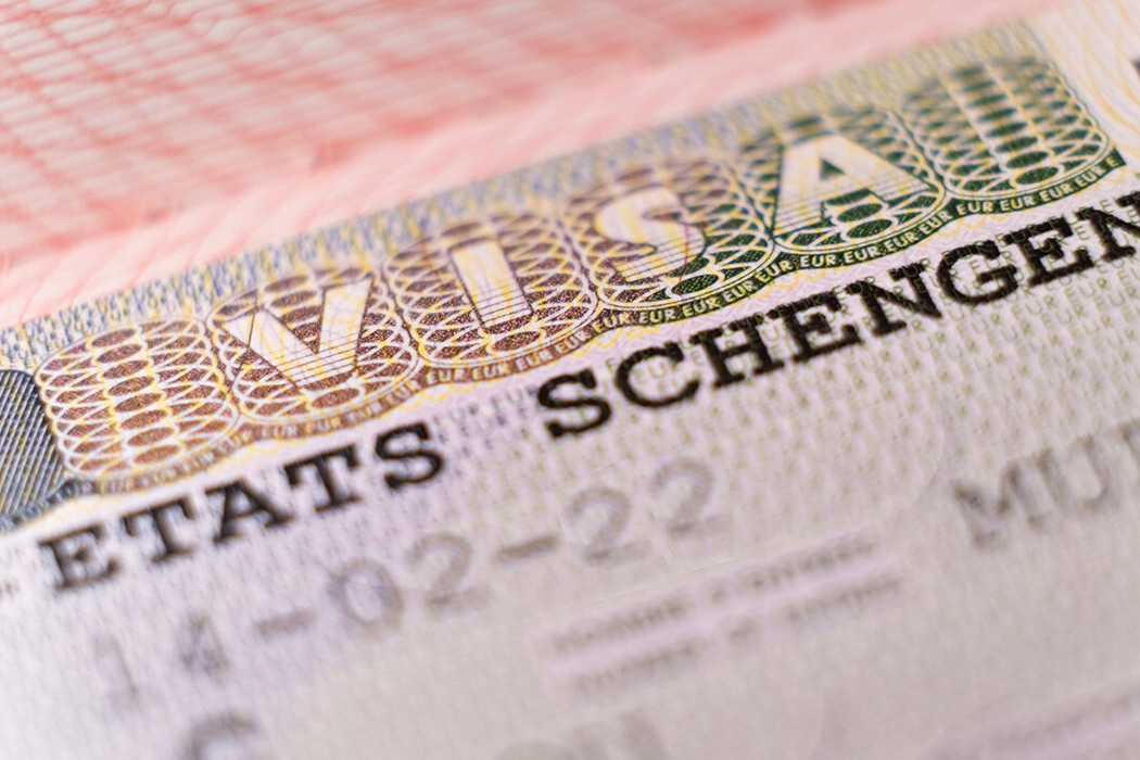 Macro shot biometric passport with schengen visa. European visitor visa for tourism and travel in EU.
