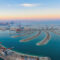 Aerial view of The Palm Jumeirah Island, Dubai Downtown skyline, United Arab Emirates or UAE. Financial district and business area in smart urban city. Skyscraper and high-rise buildings at sunset.