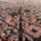 Aerial view of Barcelona City Skyline and Sagrada Familia Cathedral at sunset. Eixample residential famous urban grid. Cityscape with typical urban octagon blocks